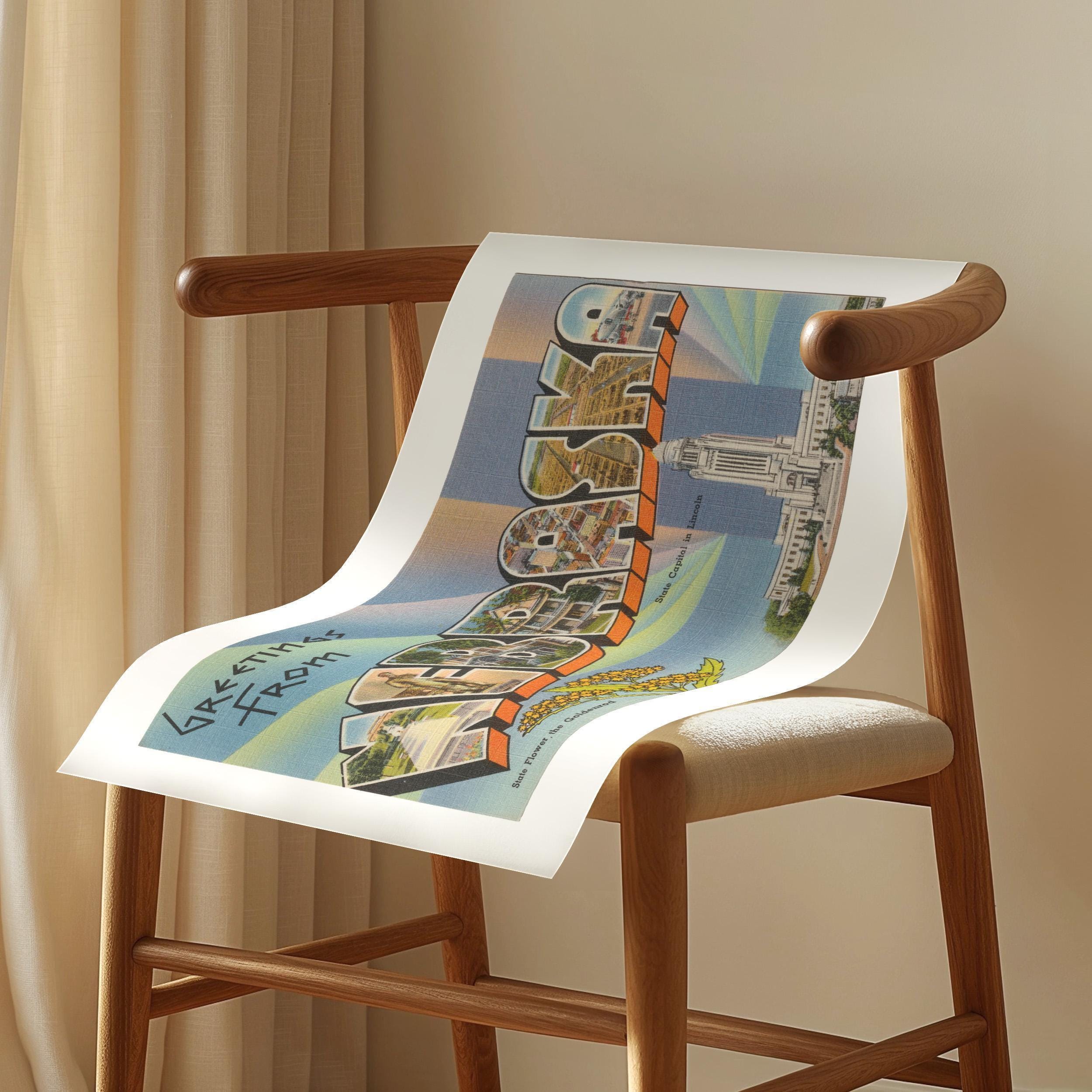 Vintage "Greetings from Nebraska" large letter postcard print, with oversized vintage-style block letters spelling NEBRASKA filled with nostalgic scenic snapshots, celebrating Nebraska as a U.S. state travel keepsake. Printed as a giclée fine art print on archival matte paper.
