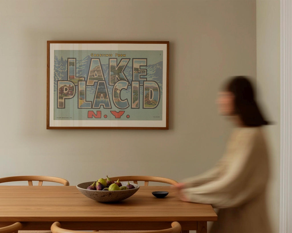 Vintage "Greetings from Lake Placid" large letter postcard print, with oversized vintage-style block letters spelling LAKE PLACID filled with nostalgic scenic snapshots, celebrating Lake Placid as a classic American city travel keepsake. Printed as a giclée fine art print on archival matte paper.