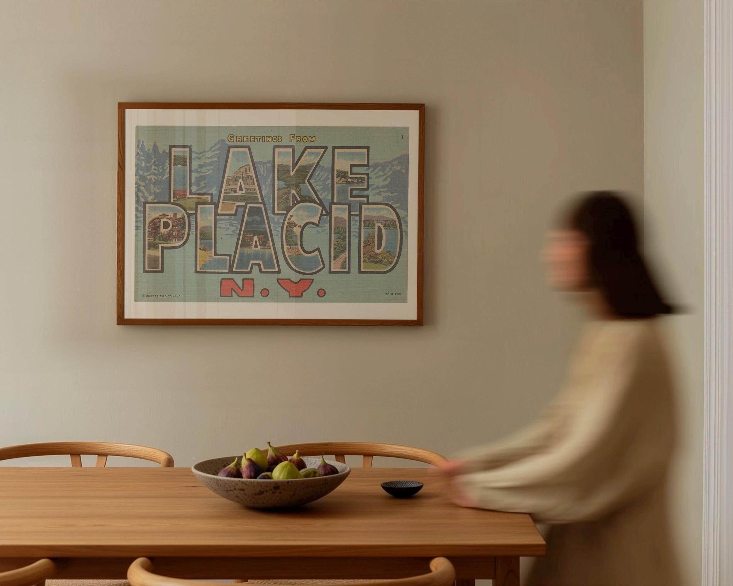 Vintage "Greetings from Lake Placid" large letter postcard print, with oversized vintage-style block letters spelling LAKE PLACID filled with nostalgic scenic snapshots, celebrating Lake Placid as a classic American city travel keepsake. Printed as a giclée fine art print on archival matte paper.