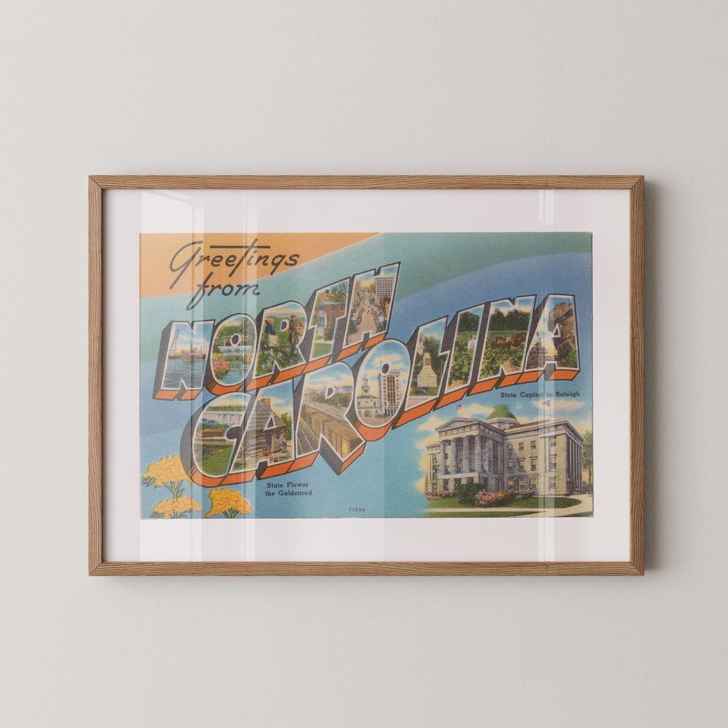 Vintage "Greetings from North Carolina" large letter postcard print, with oversized vintage-style block letters spelling NORTH CAROLINA filled with nostalgic scenic snapshots, celebrating North Carolina as a U.S. state travel keepsake. Printed as a giclée fine art print on archival matte paper.